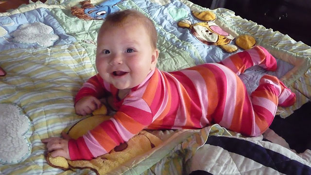 Cyan on the Pooh quilt she got from Aunt Katy.